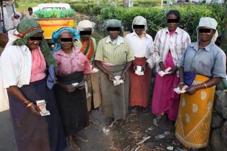 Female laborers posing with wages